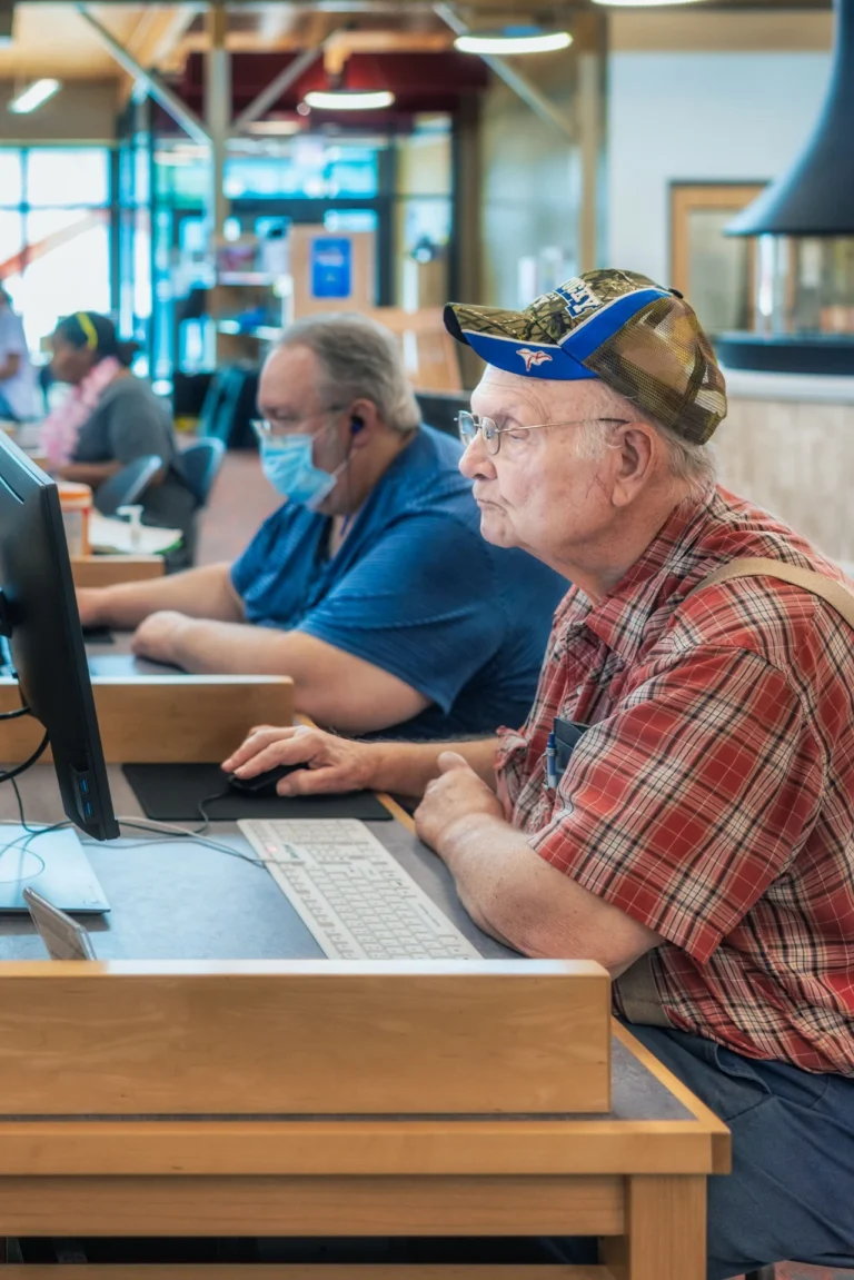 a senior man using a library computer