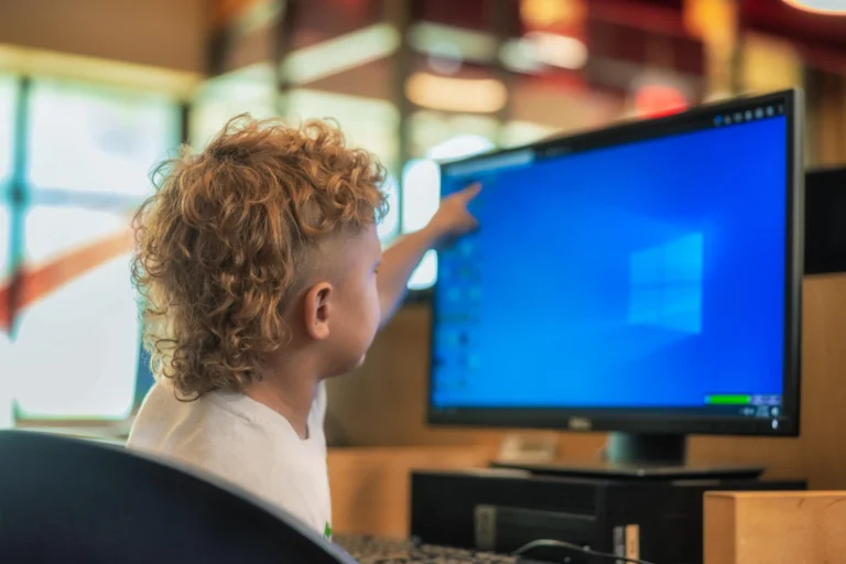 a young child using a library computer