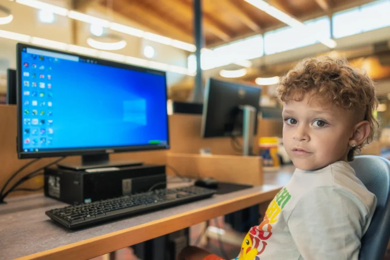 a young child using a library computer