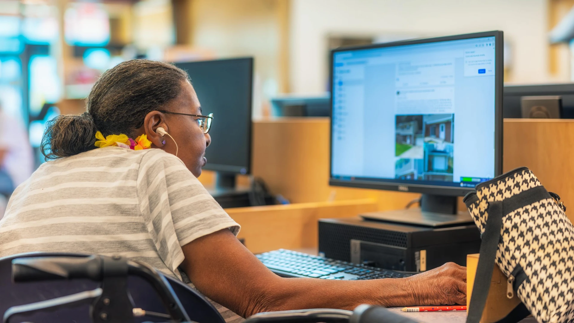 a woman using the internet on a library computer
